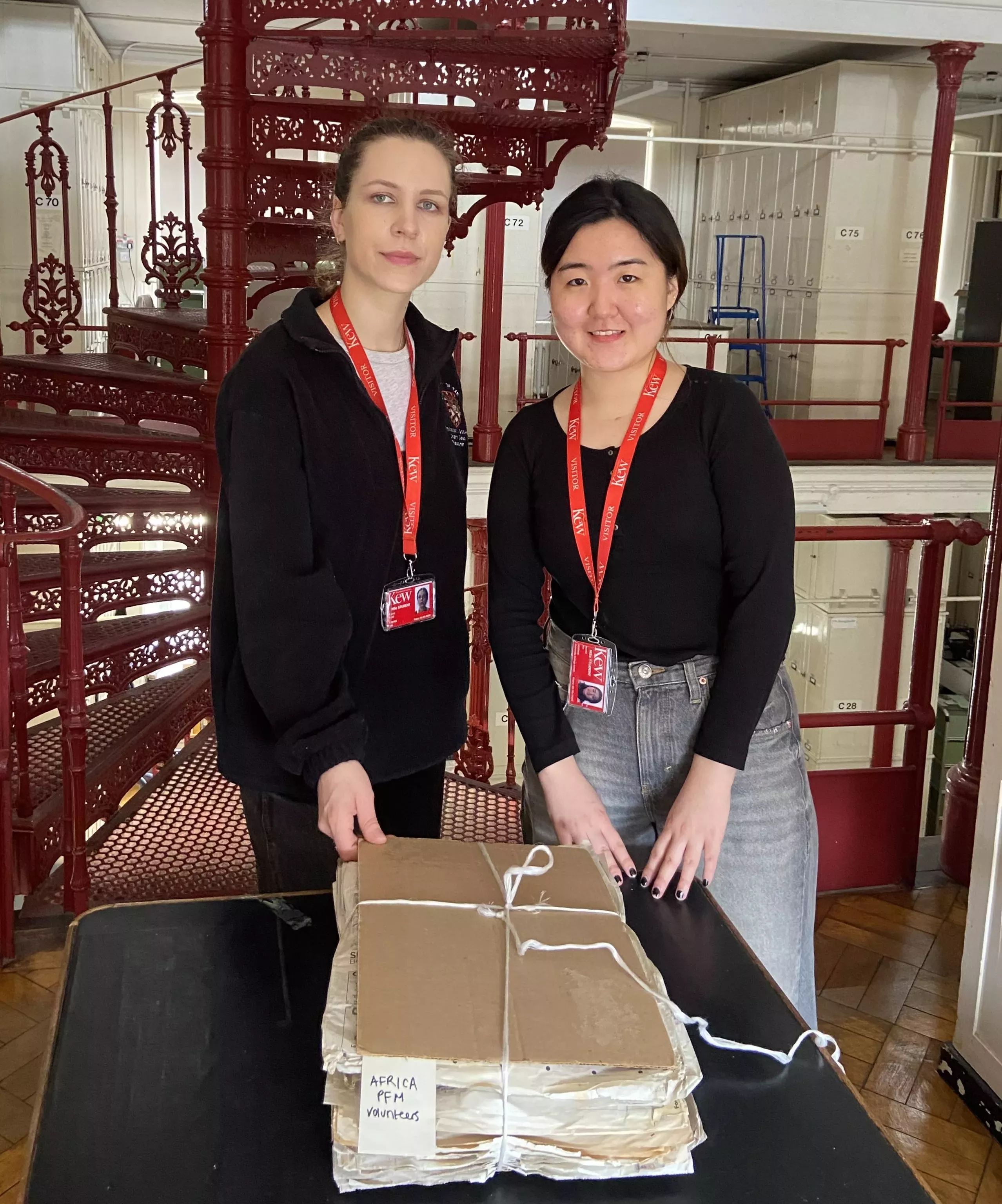 Students Chiara (left) and Runfei (right) have spent their time at Kew digging deep among new accessions to the collection © RBG Kew Two students and a folder of herbarium specimens in the kew herbarium