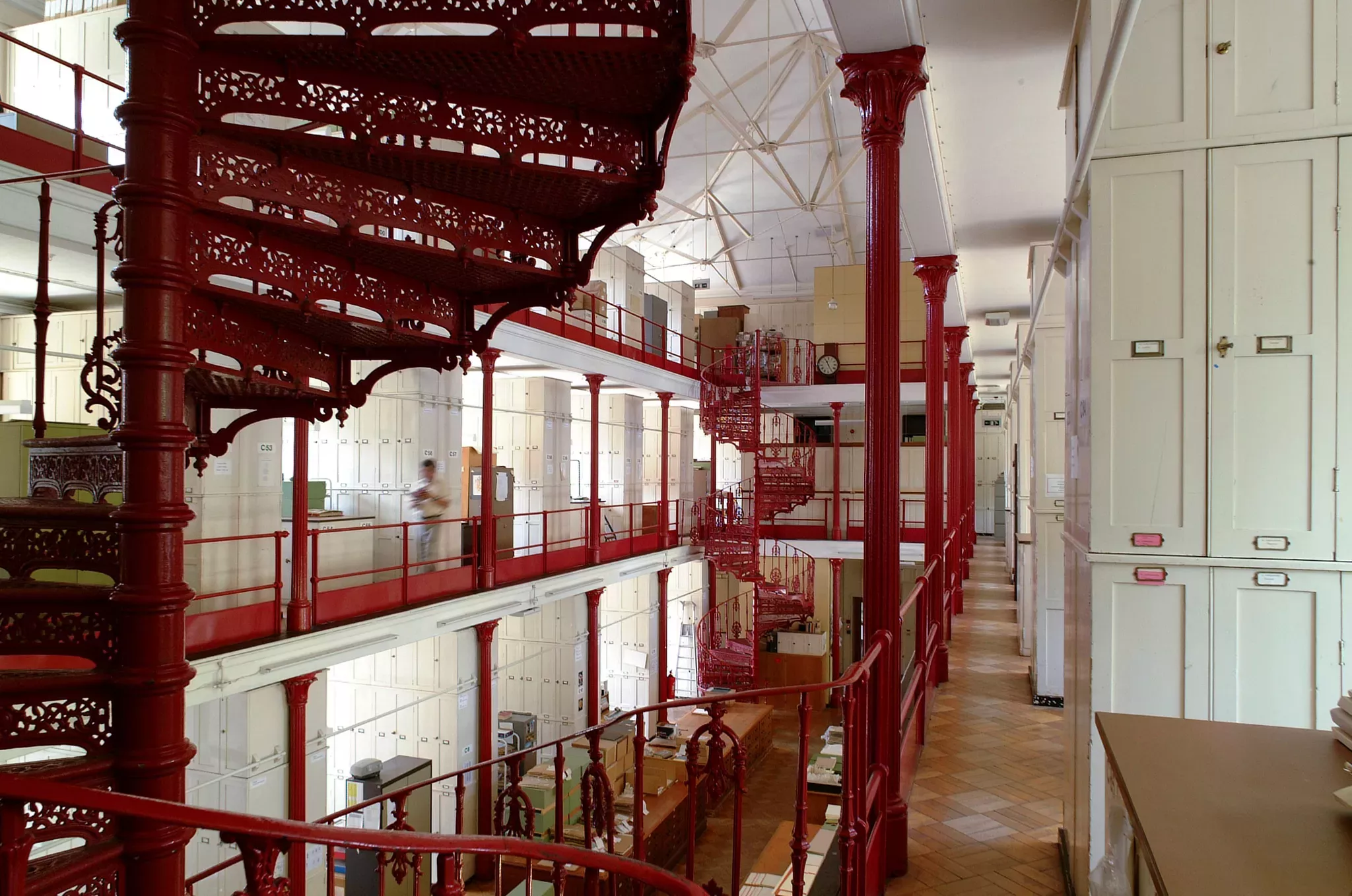 Inside Kew's Herbarium Inside wing C of Kew's Herbarium showing the red spiraling staircase from a Victorian era.