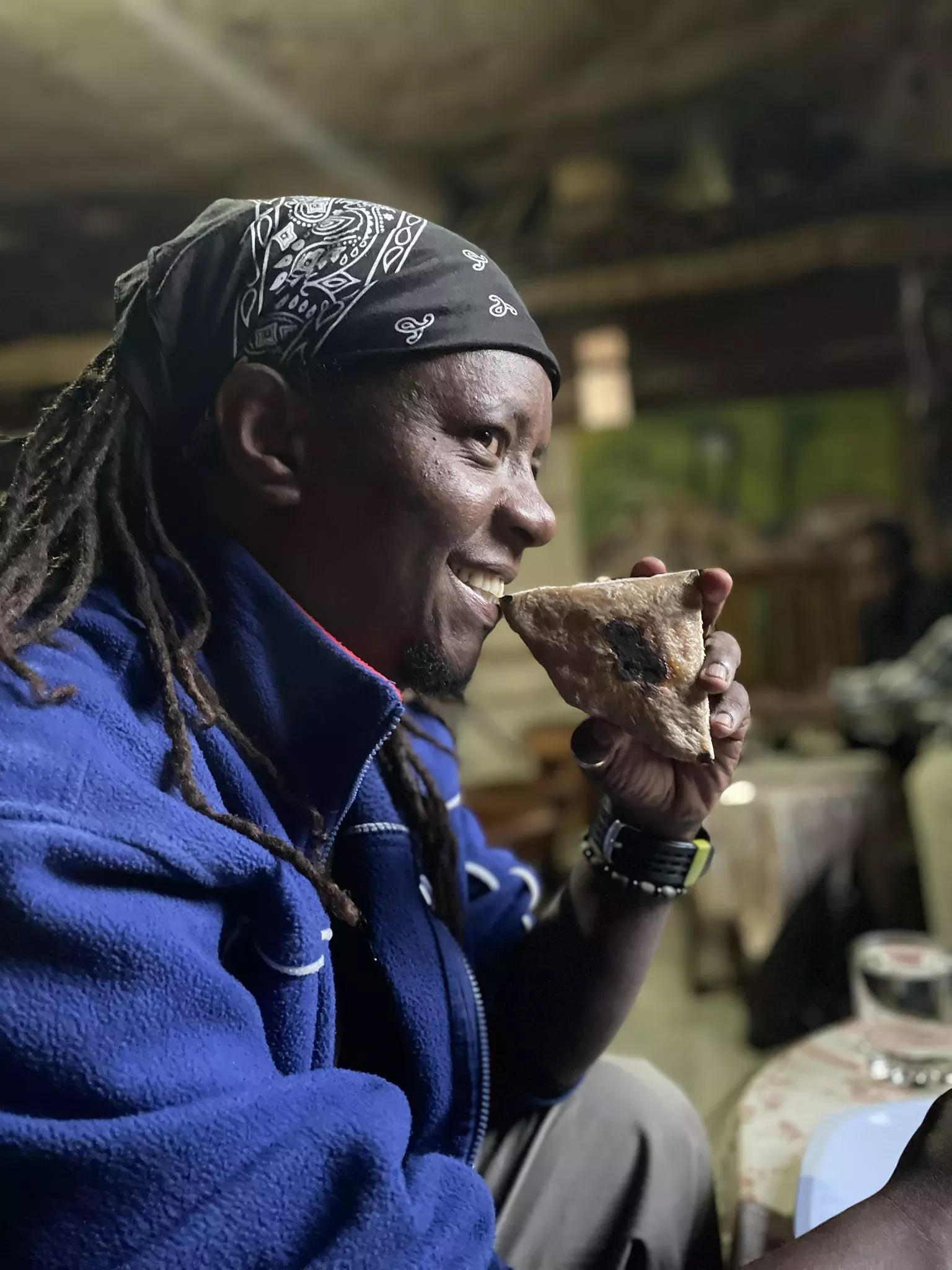 Ermias, a driver for the Kew team in Ethiopia, samples some kocho (made from enset) in a restuarant © Sophie Jago, RBG Kew A man holds a flatbread-like food to his mouth