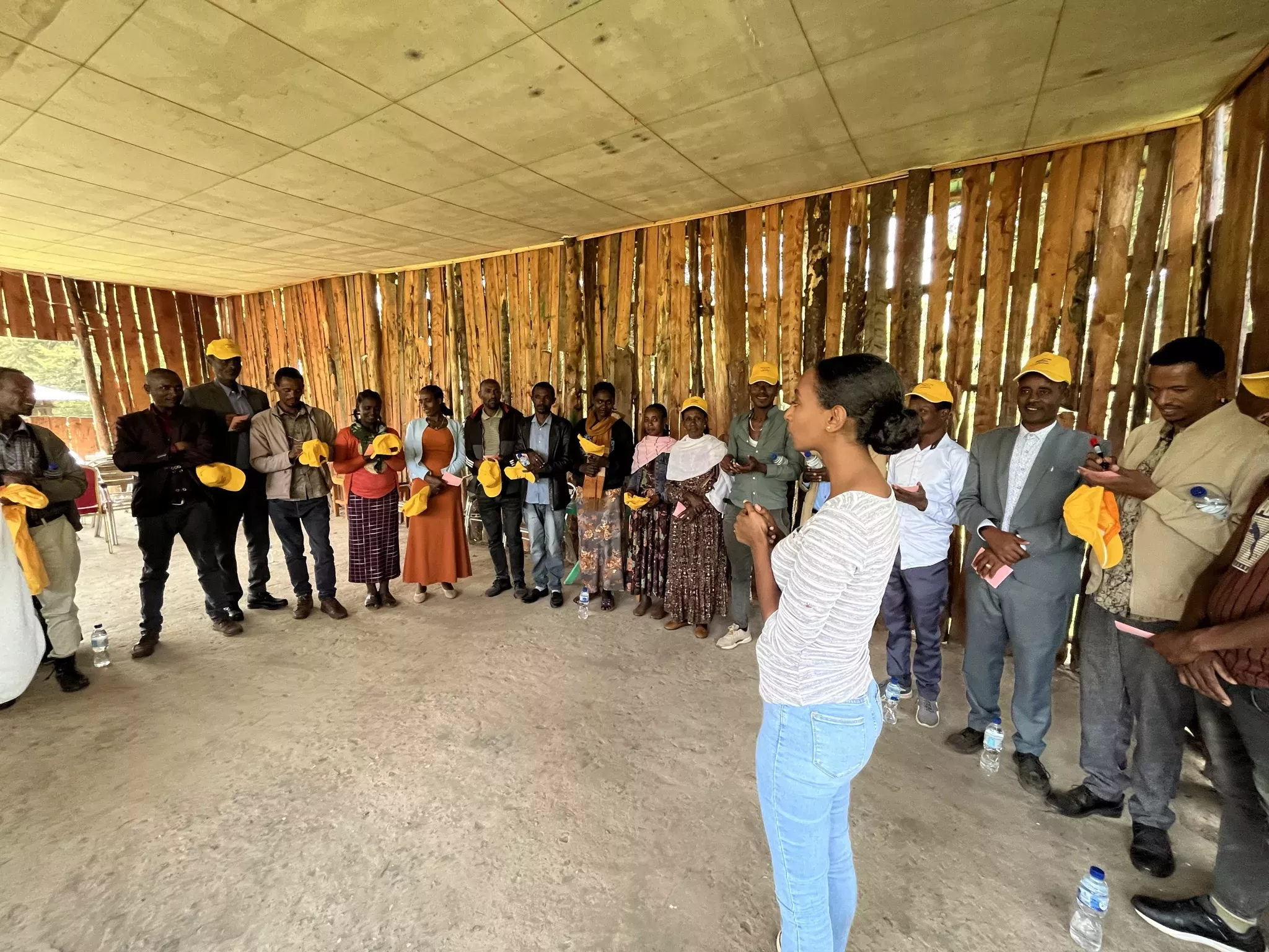 The PACS workshops in progress, attended by representatives from multiple Ethiopian communities © Sophie Jago, RBG Kew A group of people stand in a circle around a speaker