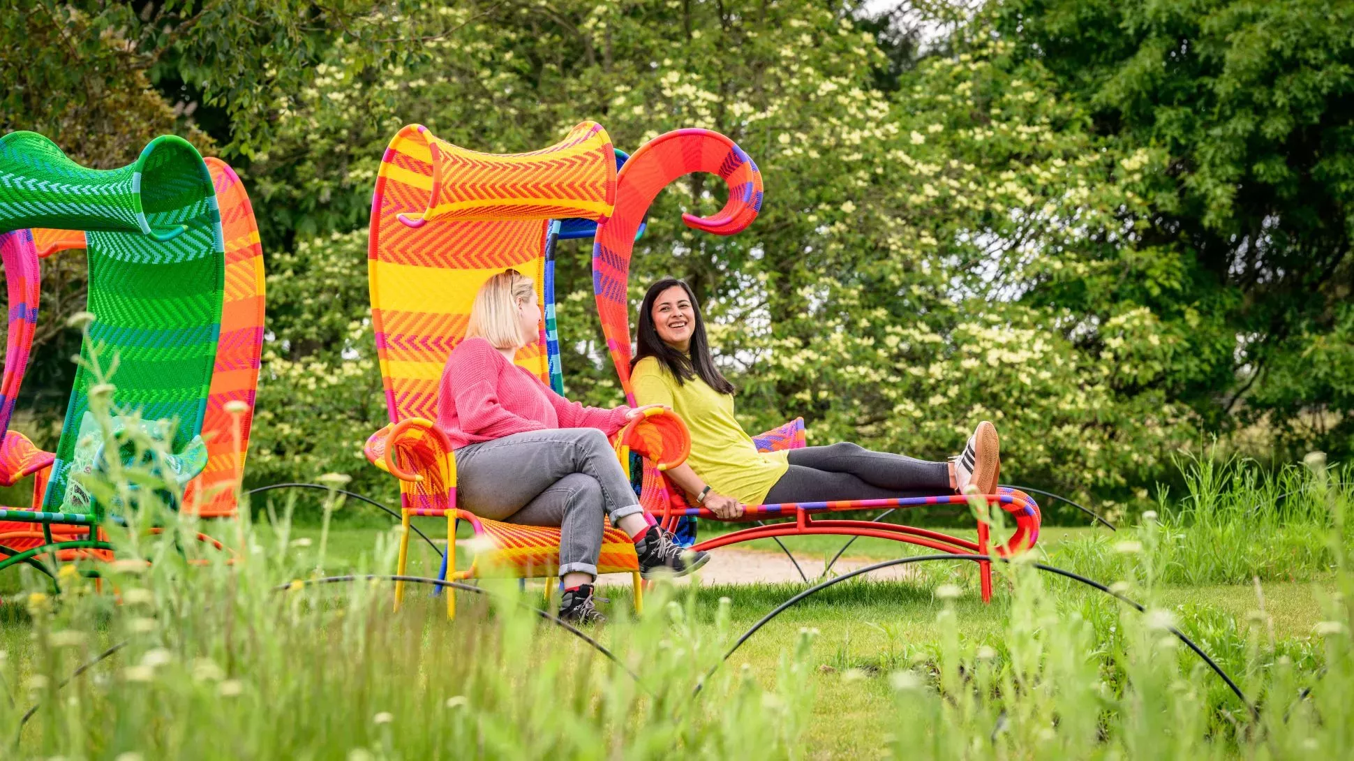 Meadow Shadow by Tord Boontje, Jim Holden © RBG Kew People sit smiling on large colourful chairs outside