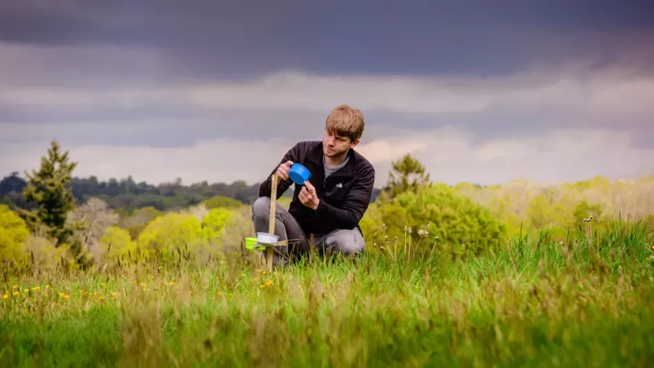 A Nature Unlocked researcher examines a monitoring station, Jim Holden © RBG Kew