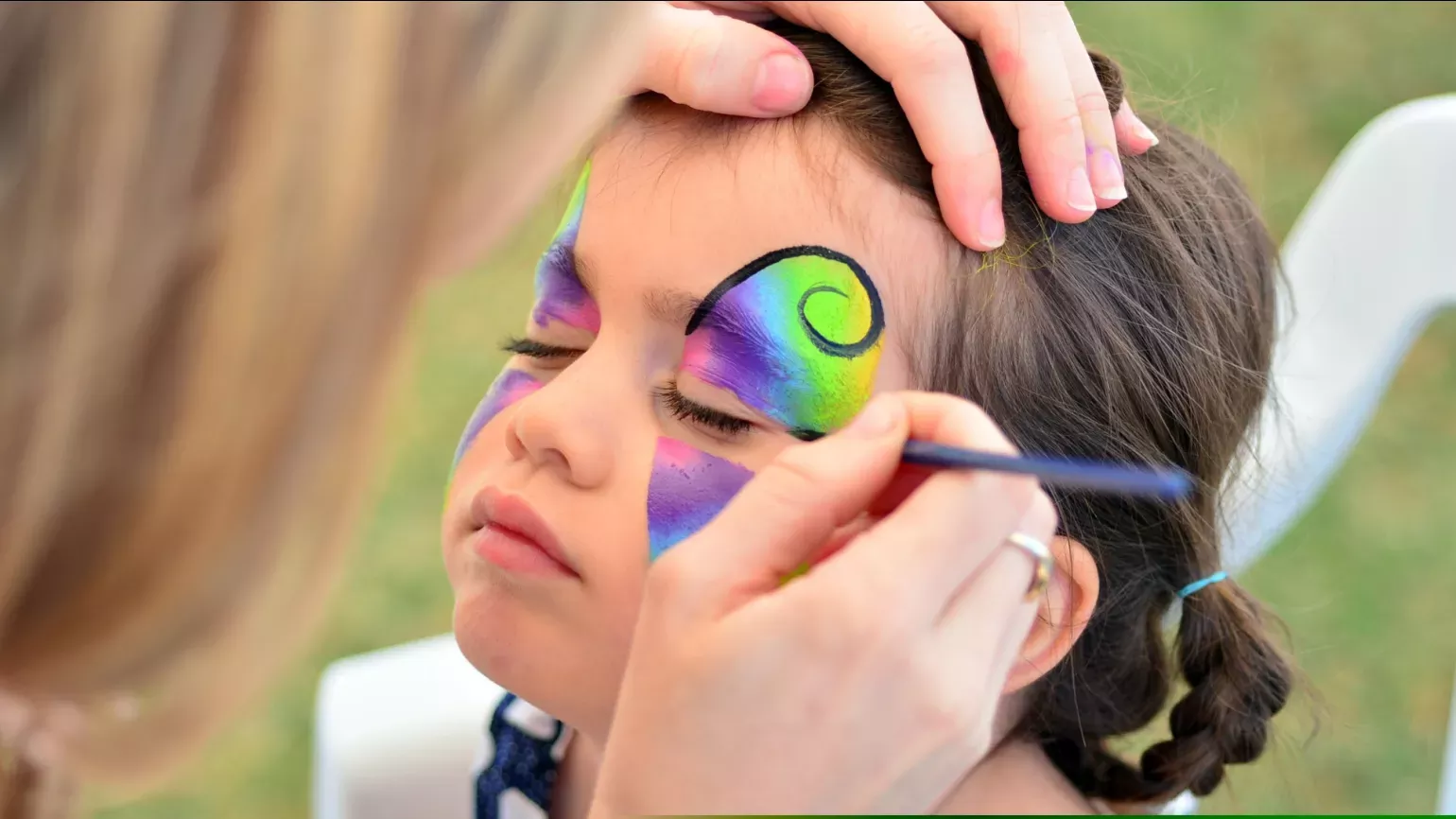 Summer Cycle © RBG Kew A young girl having colorful facepaint applied