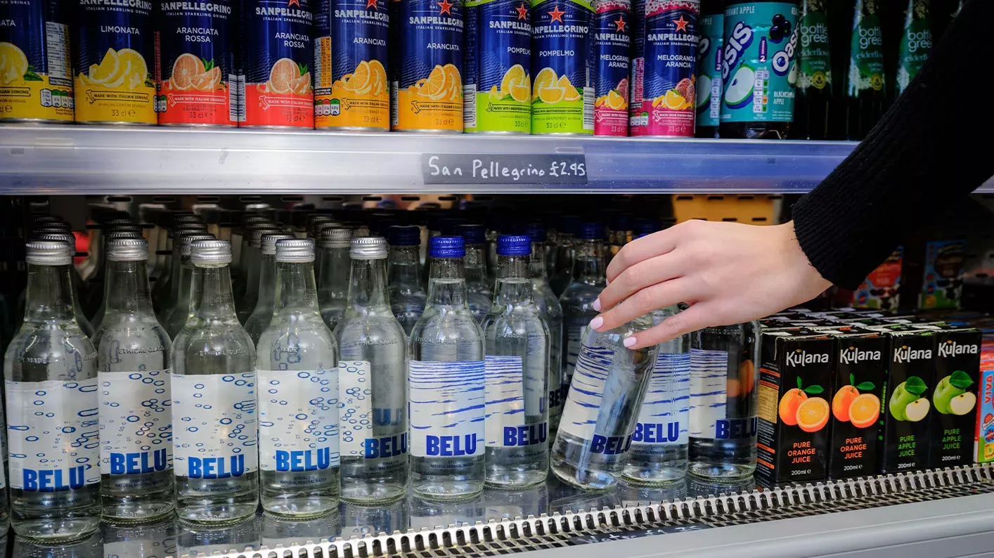 Refreshments at Wakehurst, Jim Holden © RBG Kew A woman reaches down and grabs a water bottle from a drinks fridge.